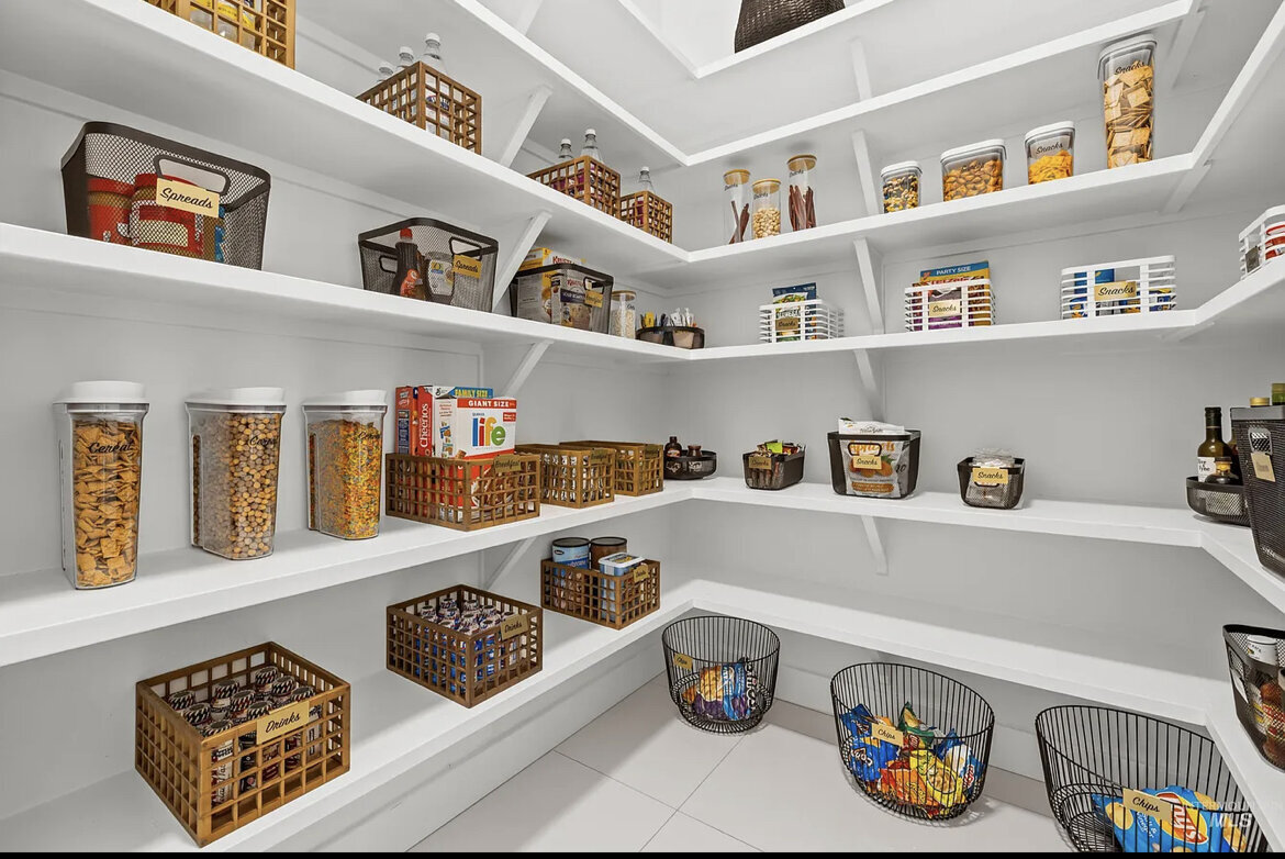 pantry with white shelves and baskets on shelves