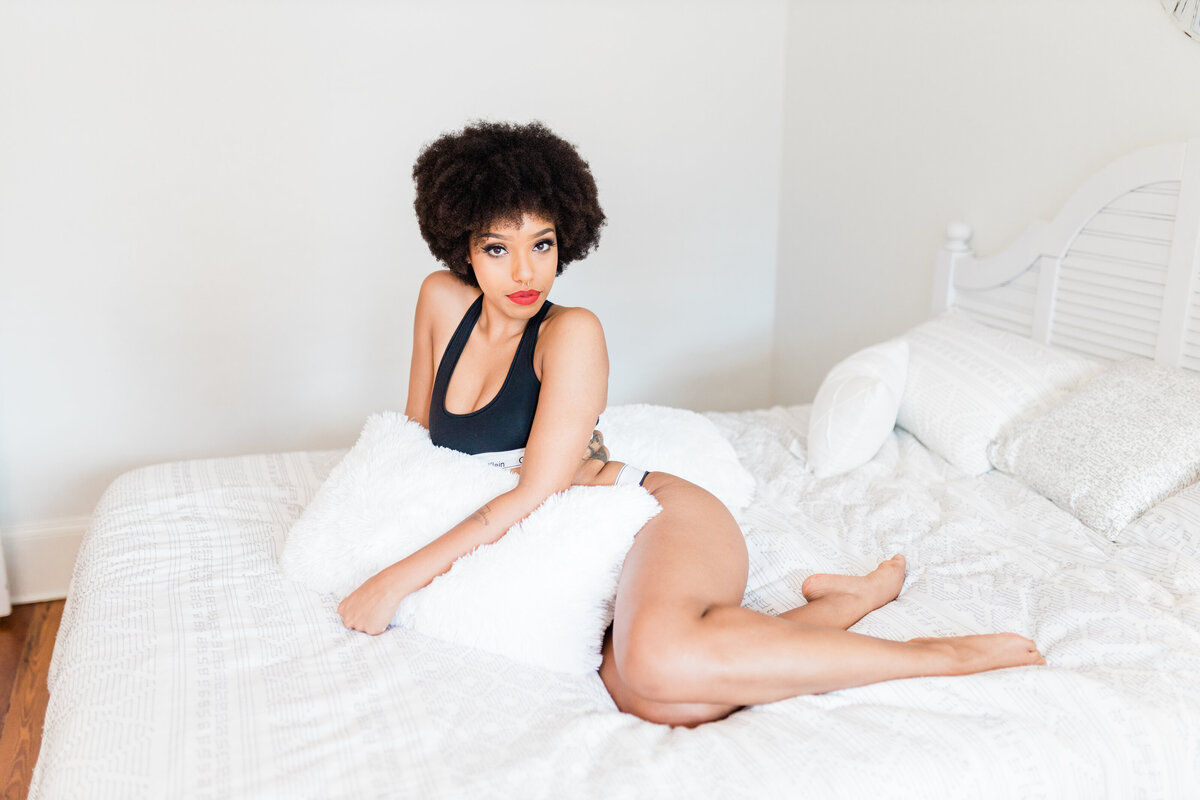 A woman in boudoir on a bed 