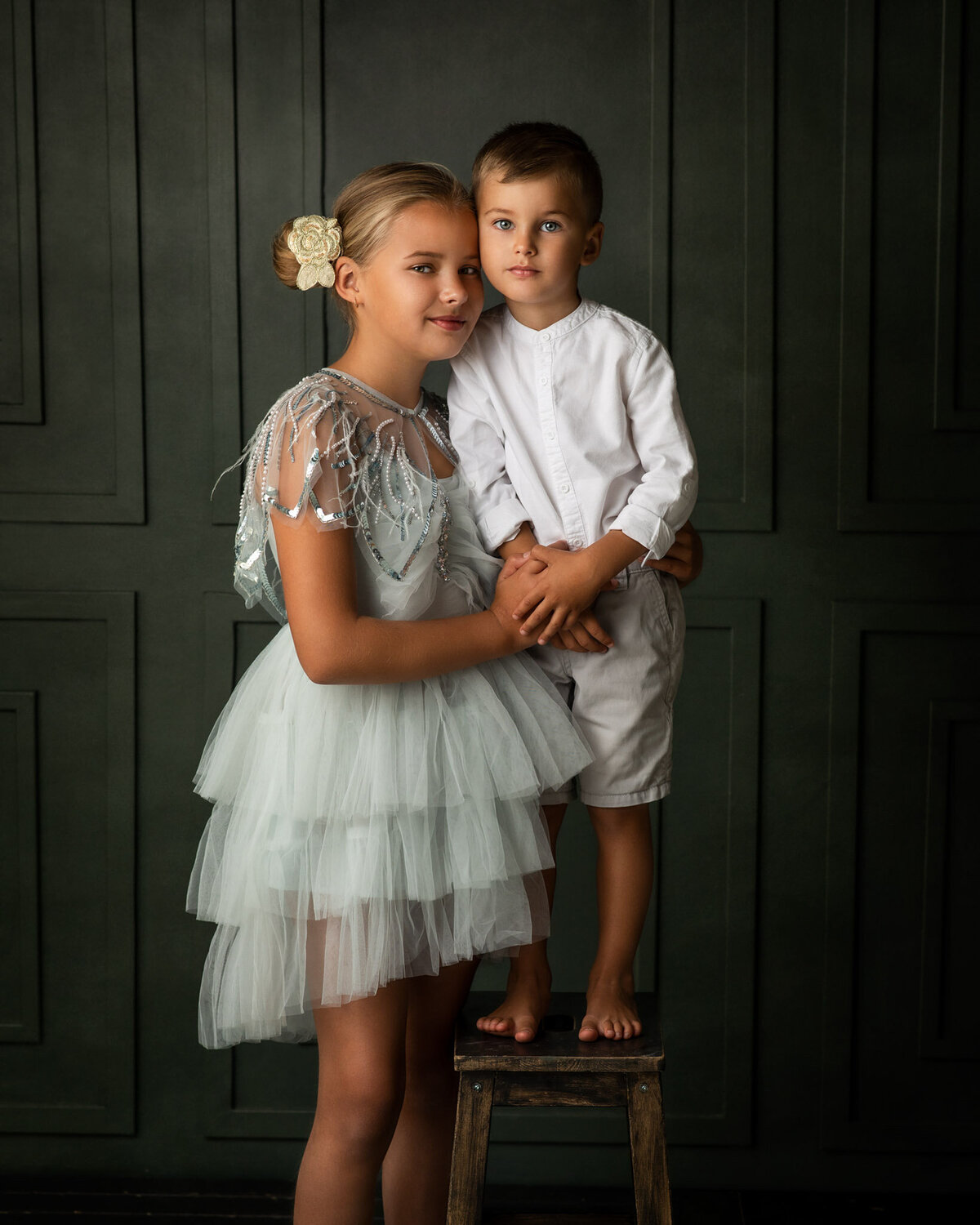 Brother and sister sharing a moment posing at RS Portrait Photography studio in London, Beckenham
