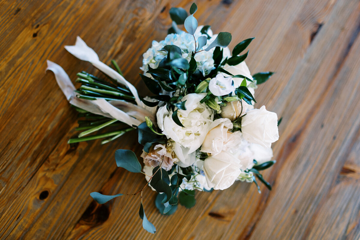 wedding bouquet with lots of greens and white flowers