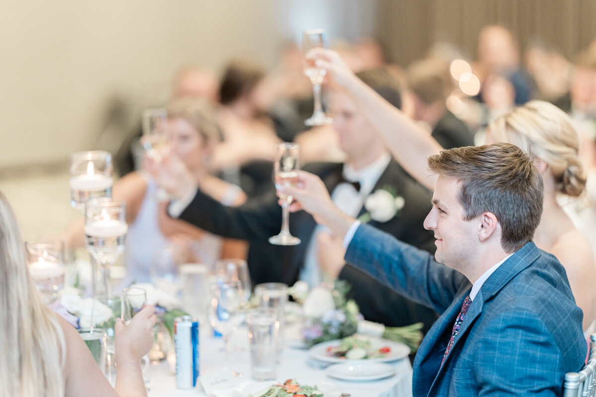 Wedding guests toasting the happy couple.