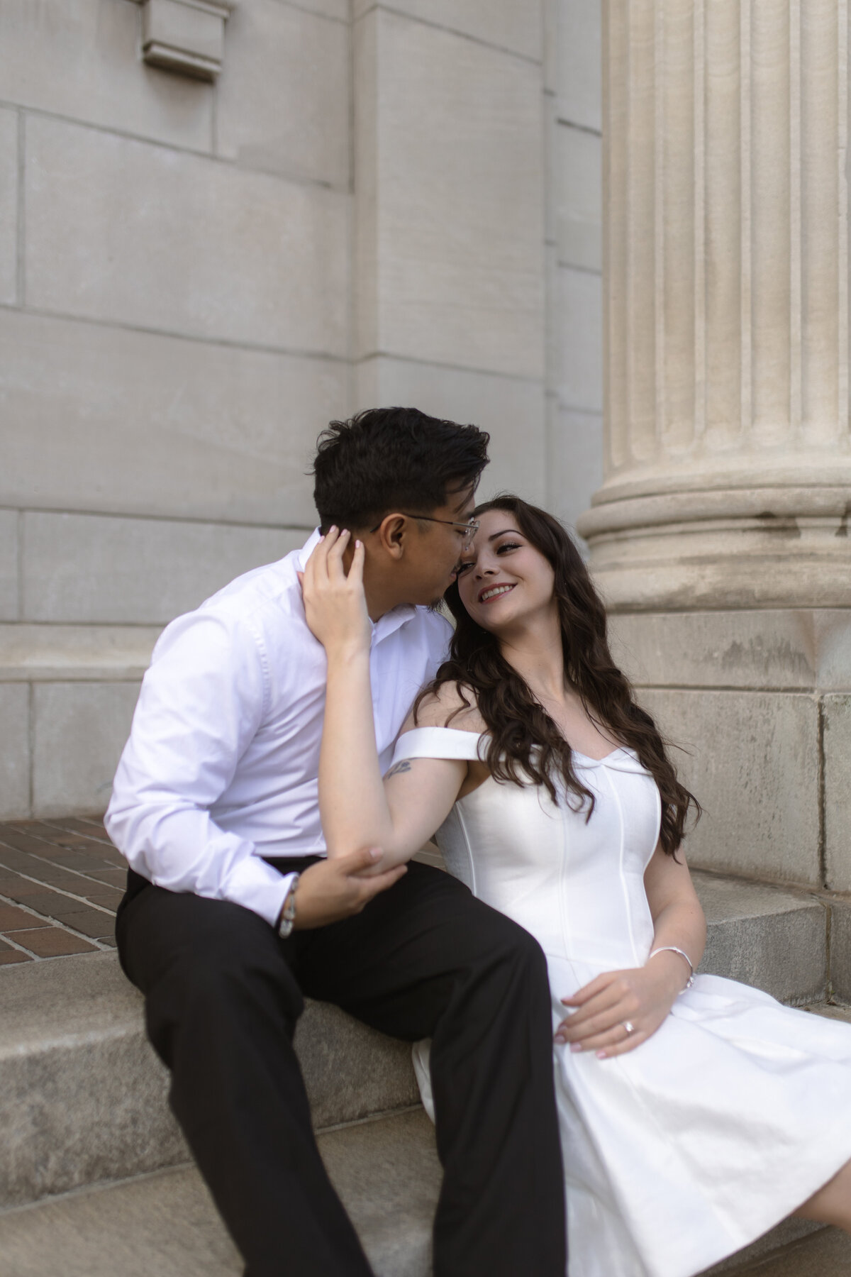 Pre-wedding photoshoot with the future bride and groom. Dressed in a classy white dress. Photo taken in Downtown Jacksonville, by Phavy Photography, Jacksonville Engagement Photographer