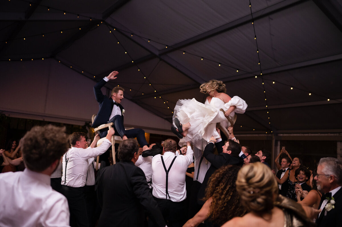 A couple doing the hora with their family at their wedding on Ponce City Market Rooftop in Atlanta, GA