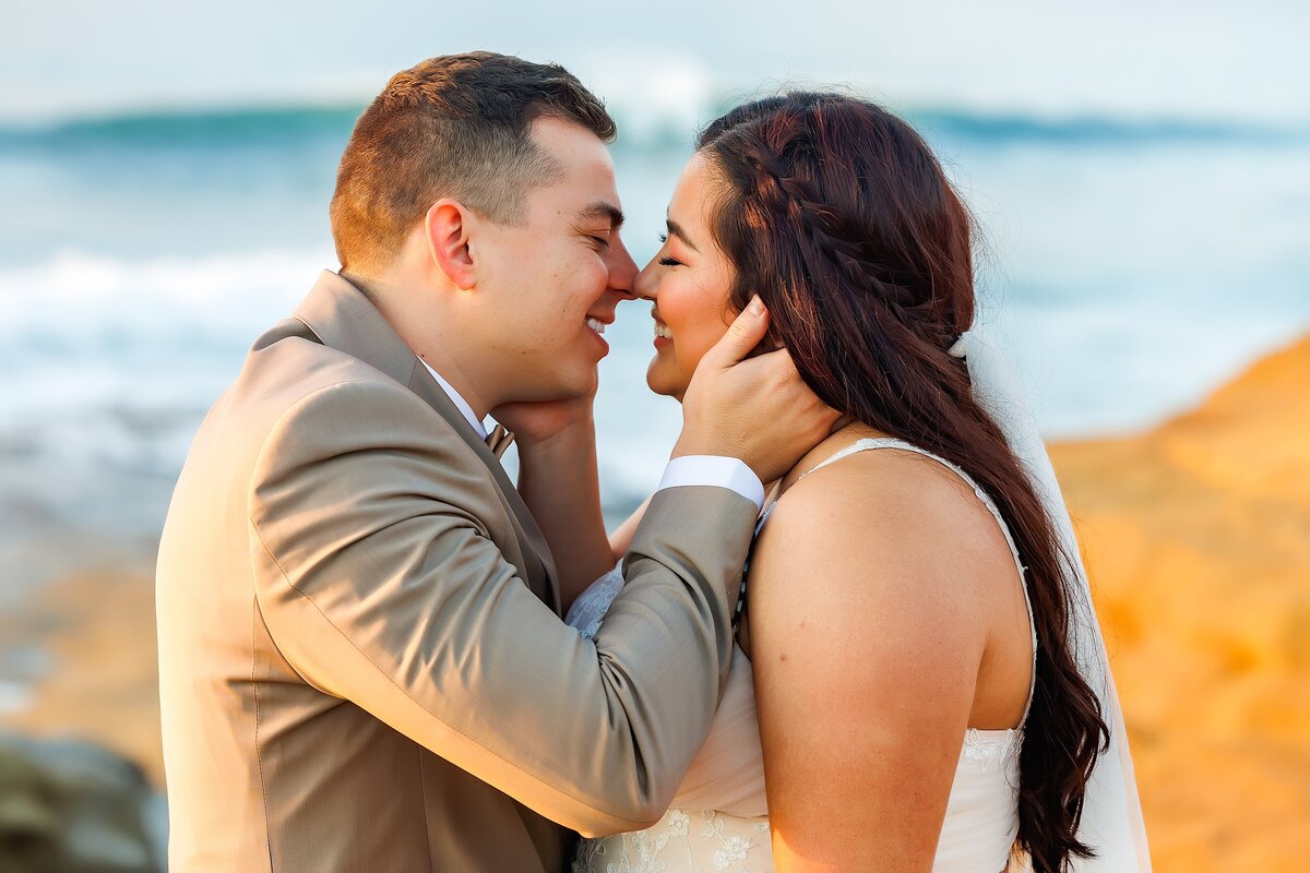 Bride and groom kissing at Sunset Cliffs