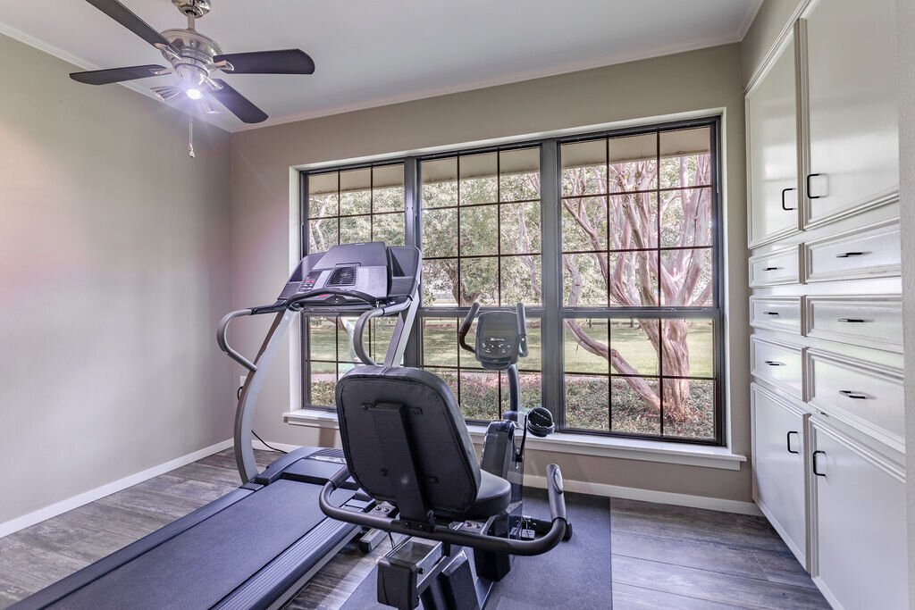 Exercise room with treadmill and exercise bike in this 5-bedroom, 4-bathroom vacation rental house for 16+ guests with pool, free wifi, guesthouse and game room just 20 minutes away from downtown Waco, TX.