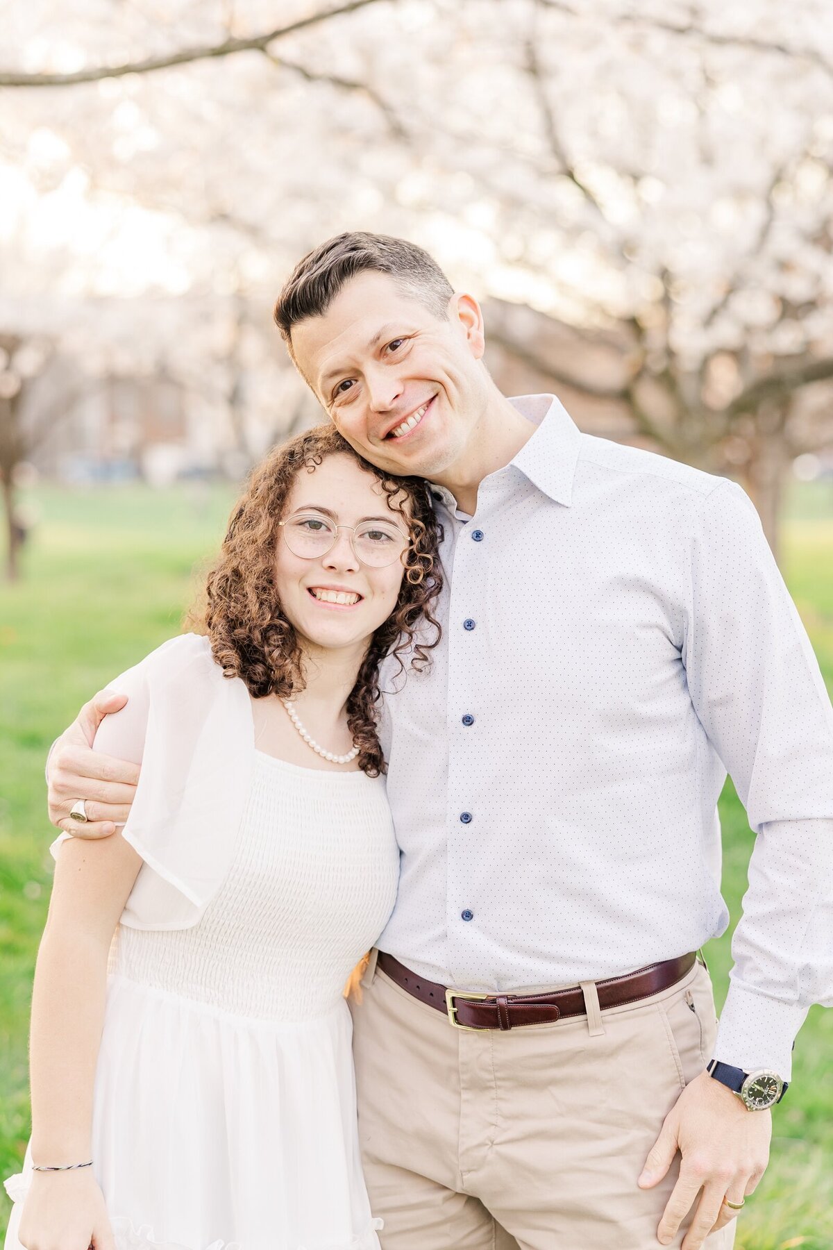 Dad smiling with his teenage daughter by an Ohio family photographer