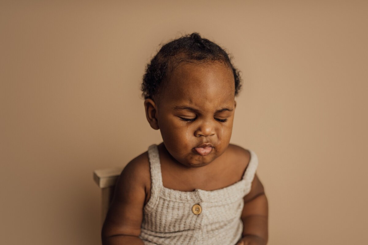 boy frowns during 6 month baby session in tampa