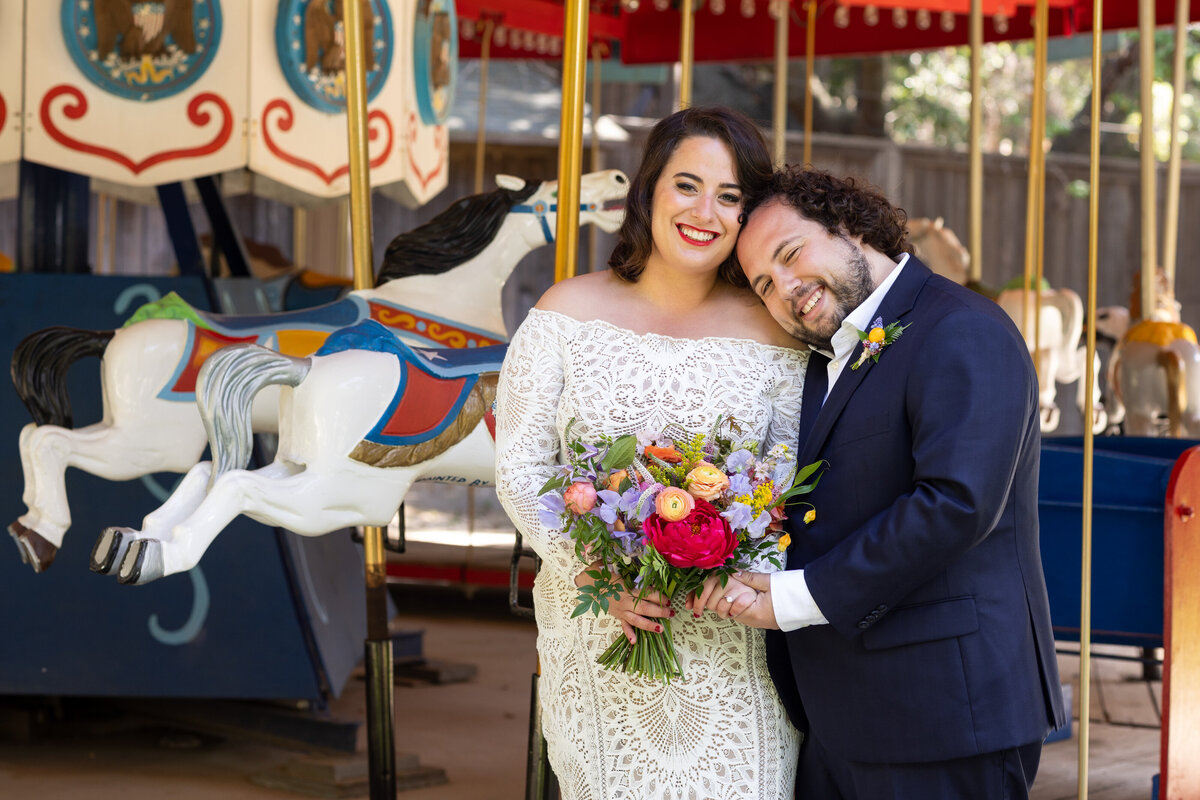 A groom resting his head on his bride's shoulder