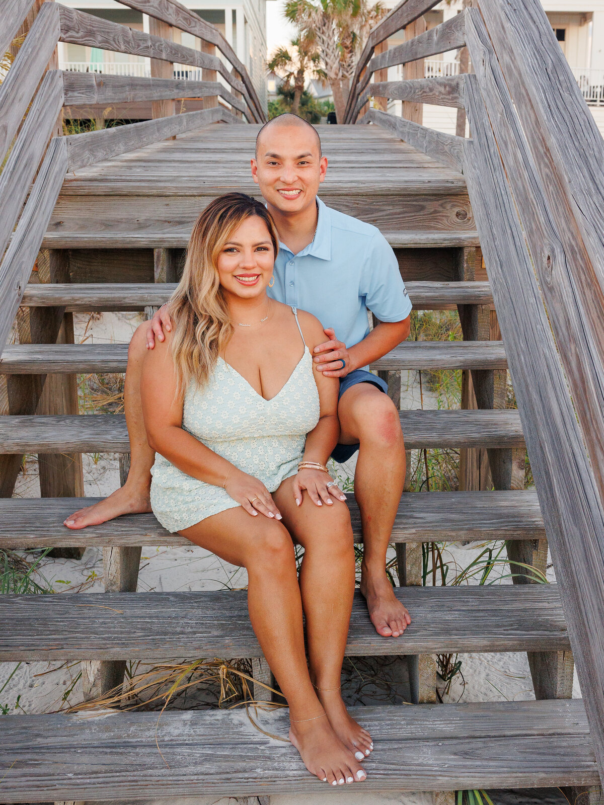 Mother and Father posing on steps of boardwalk