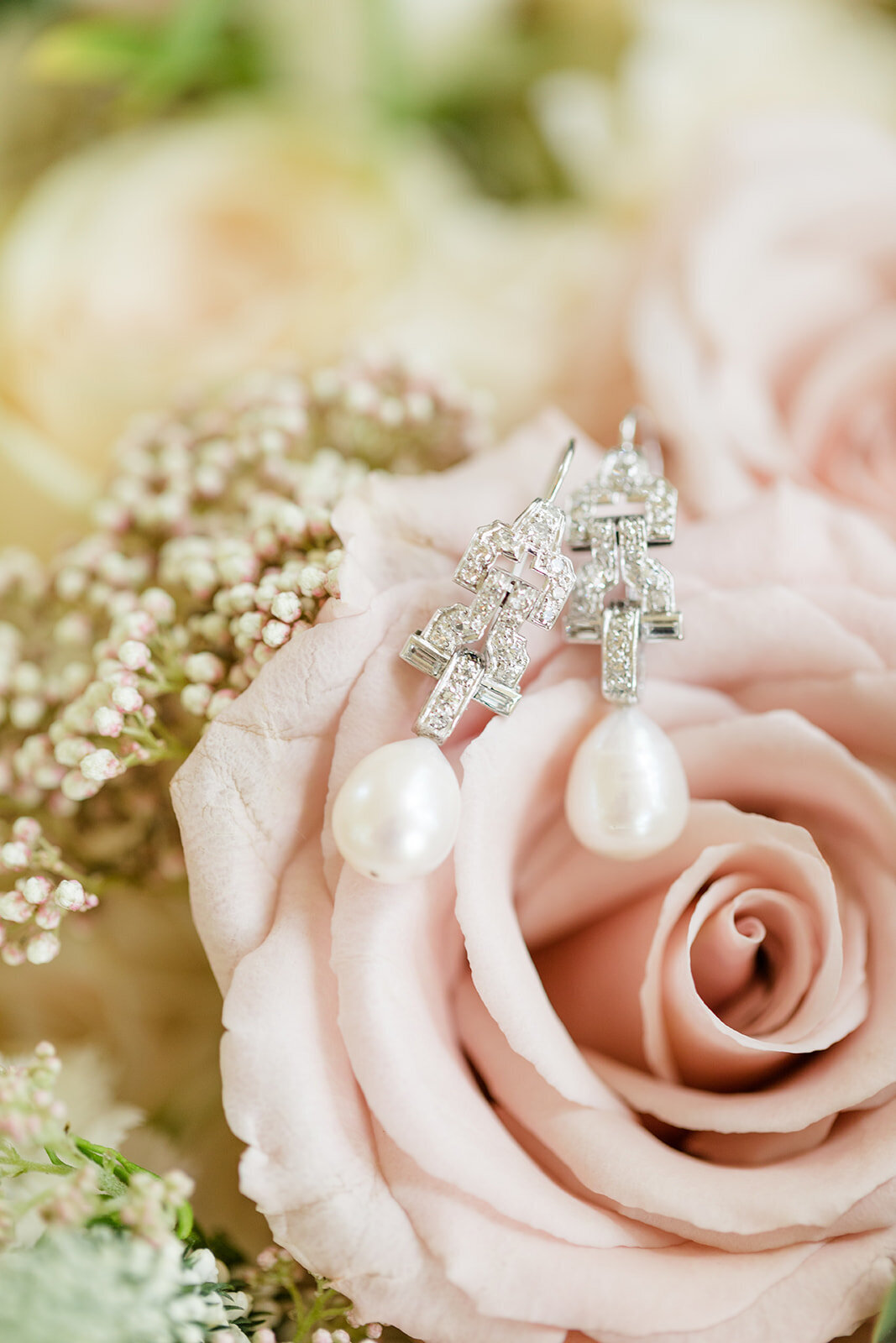 Earrings on a rose; bridal details