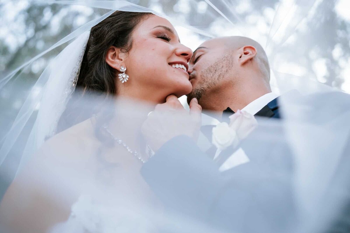 Bride and groom veil shot captured by Fort Myers wedding Photographers