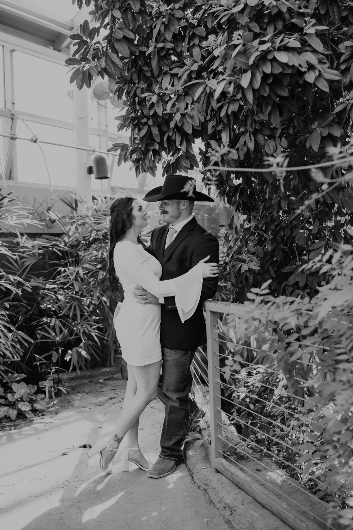 couple standing in greenhouse in amarillo botanical gardens