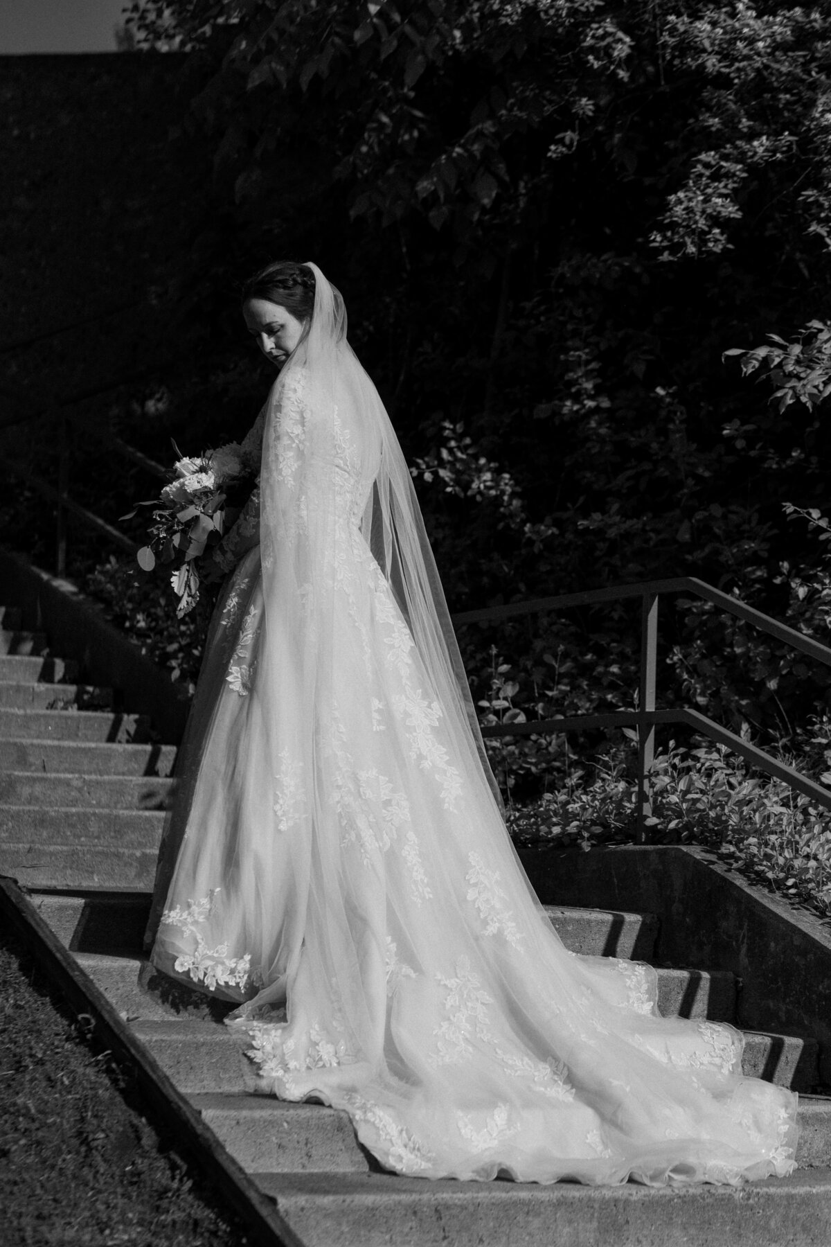 Solo portrait of a bride in black and white, with her looking over her shoulder