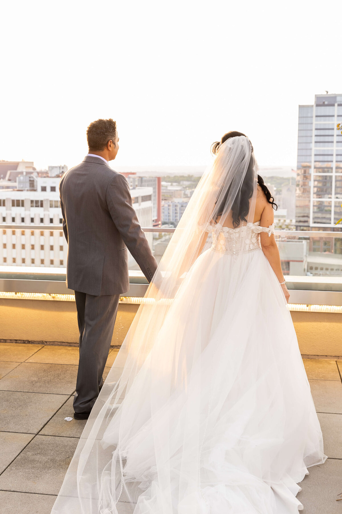 Bride and groom looking out at Nashville city