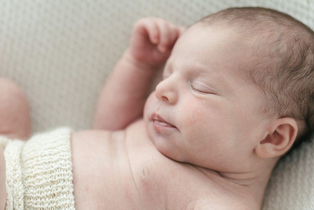 close up photograph of newborn babies profile whilst they sleep