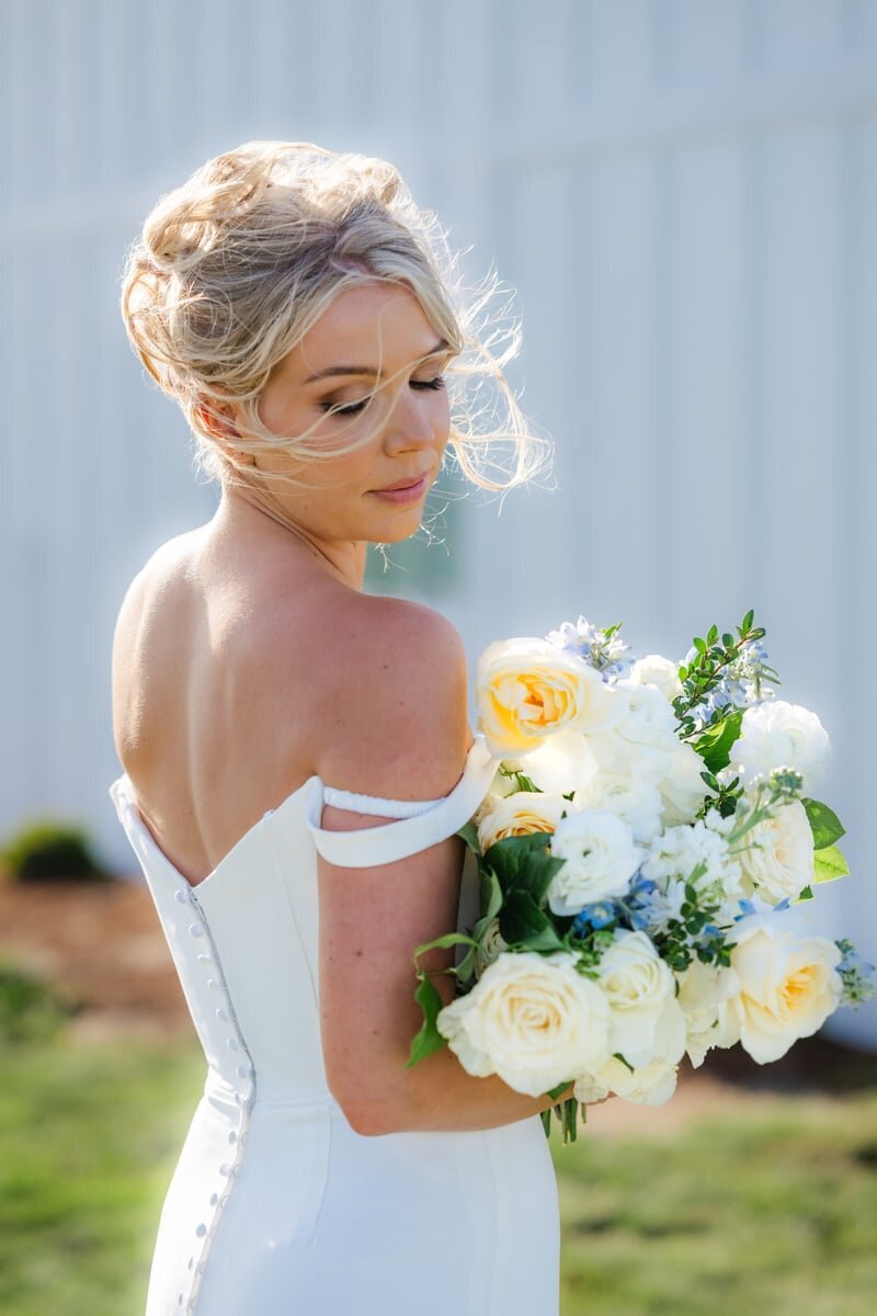 close image of bride with bouquet in yellow and white
