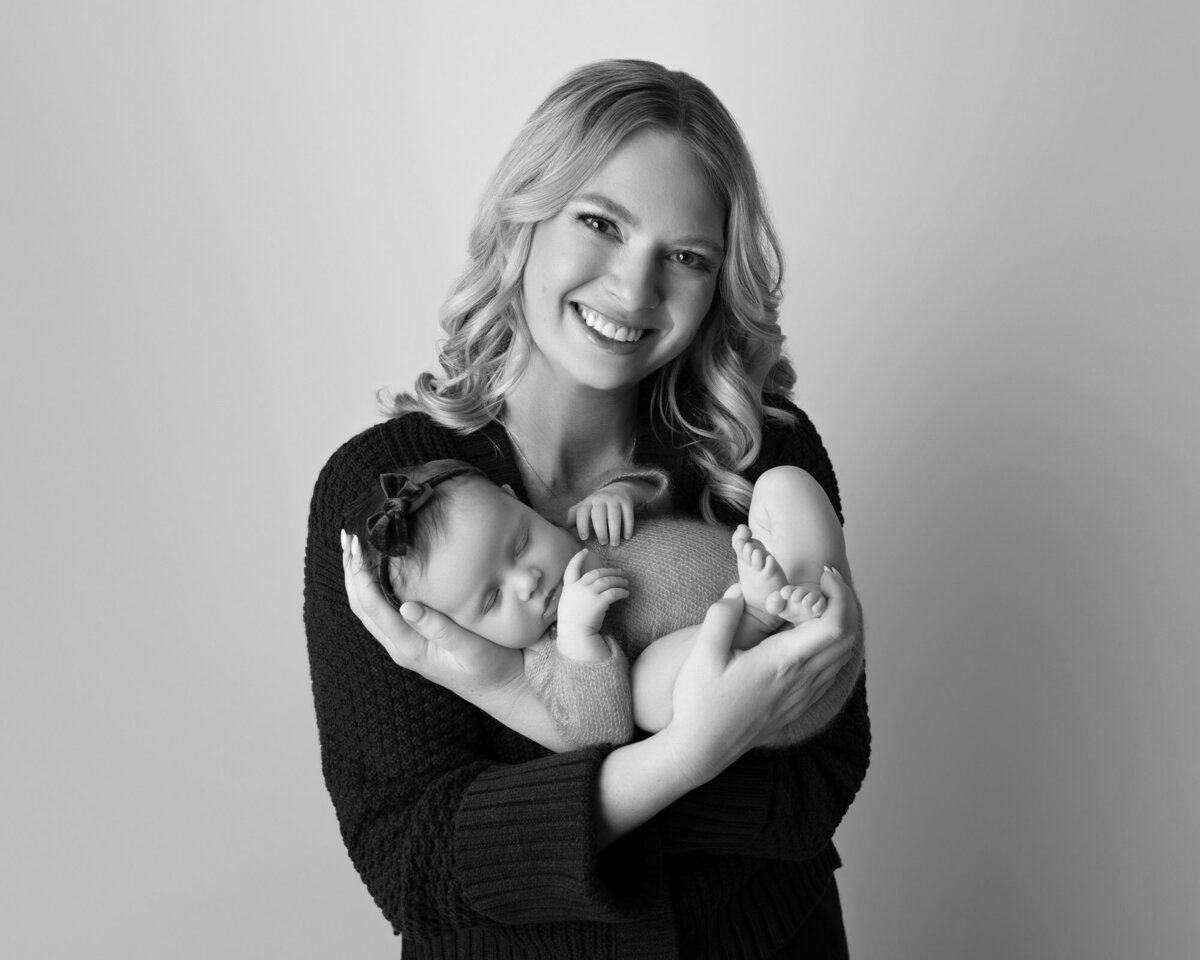 Mother holding newborn baby Westlake professional family photographer