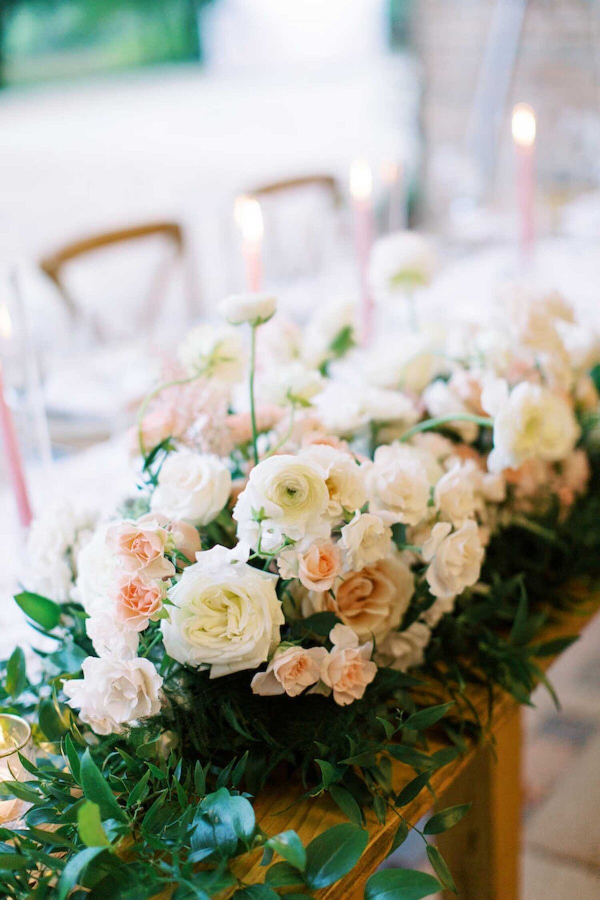 Dramatic and lush floral table runner down the head table at a luxury Chicago outdoor garden wedding.