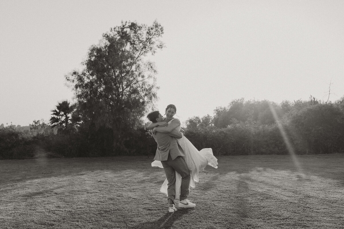 wide photo of bride and groom spinning