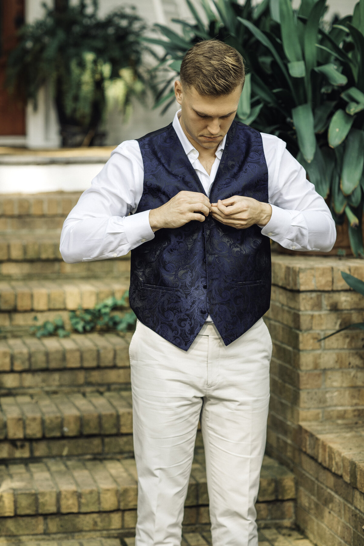 Wedding Photograph Of Man Buttoning His Vest Los Angeles