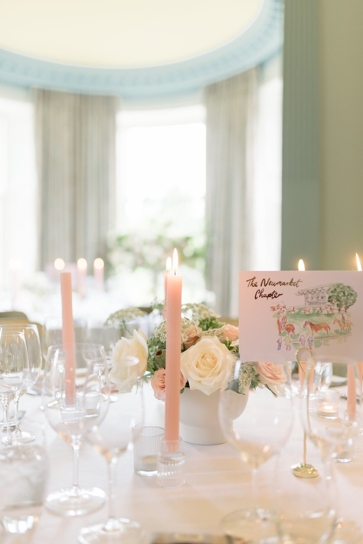 Candlelit wedding tables with pink taper candles in Cromlix House, captured by destination wedding photographer in Scotland.