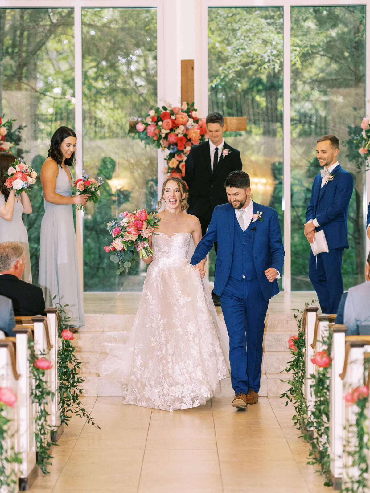 Newly married bride and groom walk down the aisle at Ashton Gardens wedding venue in Dallas Texas