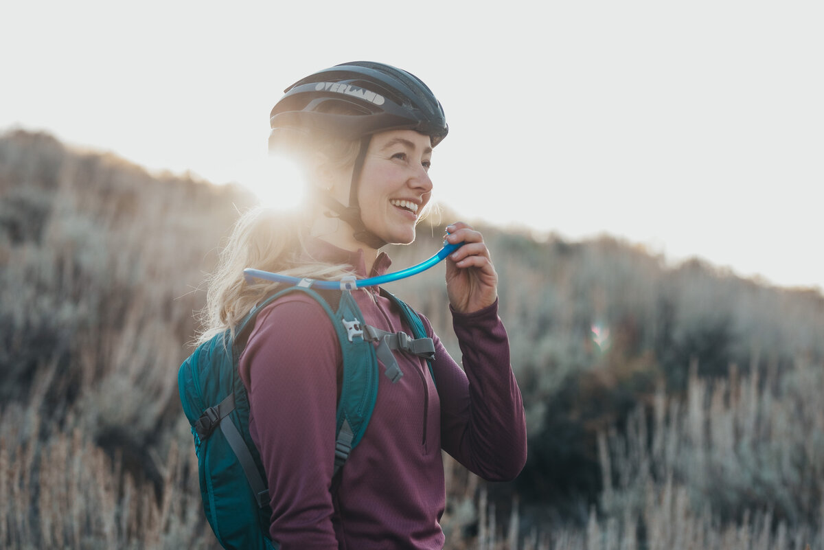 girl drinking water on her bike ride