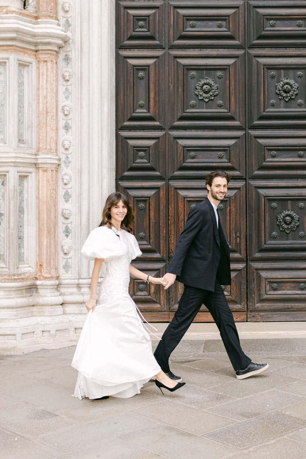 engaged couple in front of Basilica San Marco
