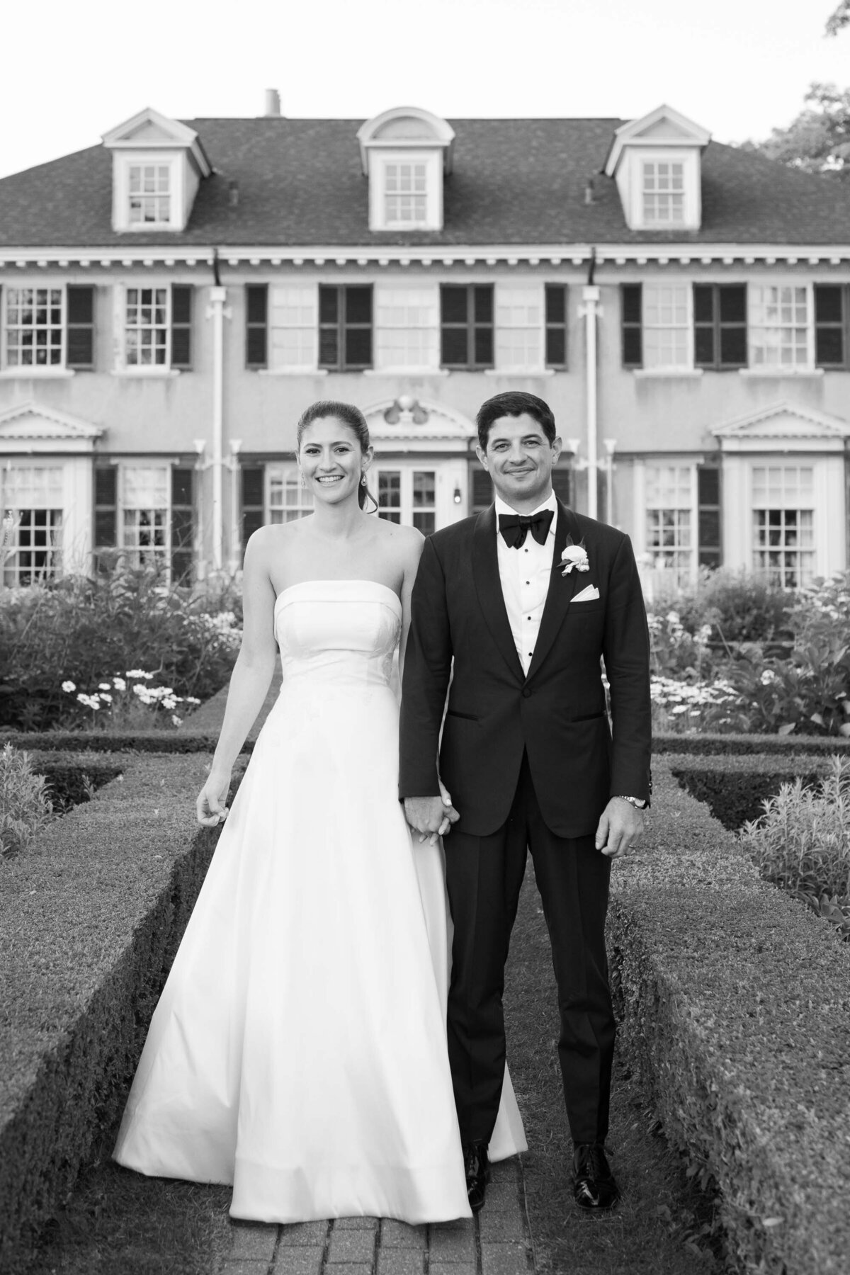 bride and groom walk through the gardens at hildene wedding in manchster, vt