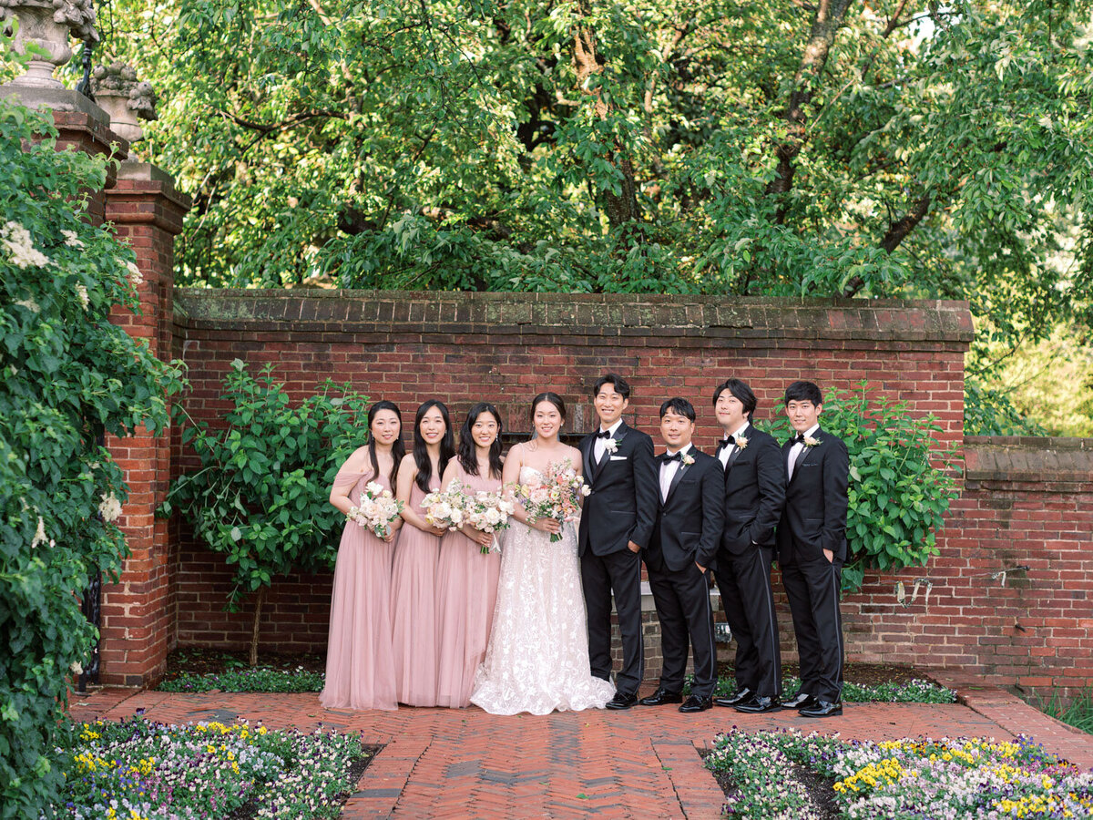 Outdoor photo of wedding couple and their entourage