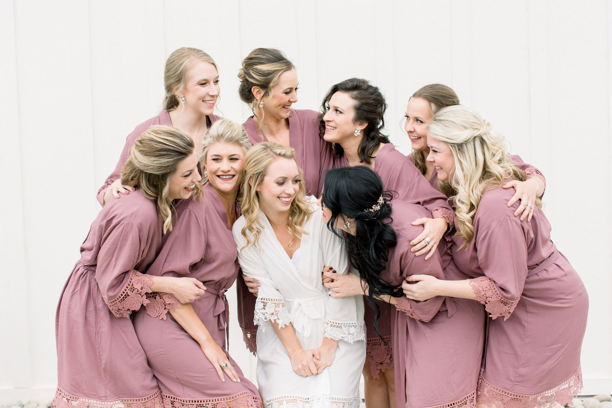 Bride getting ready with bridesmaids in matching robes