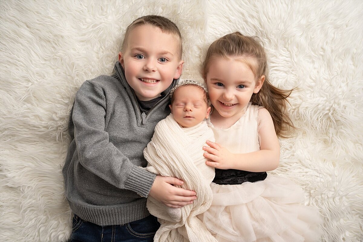 siblings with newborn photo