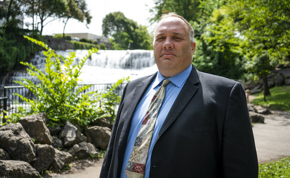 Professional headshot for a lawyer near a waterfall