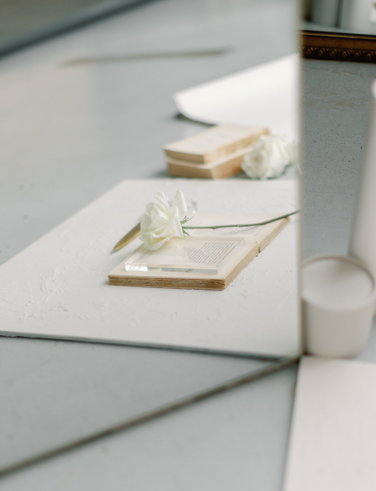creative florist brand photography, mirror reflection photo, single white rose, antique book