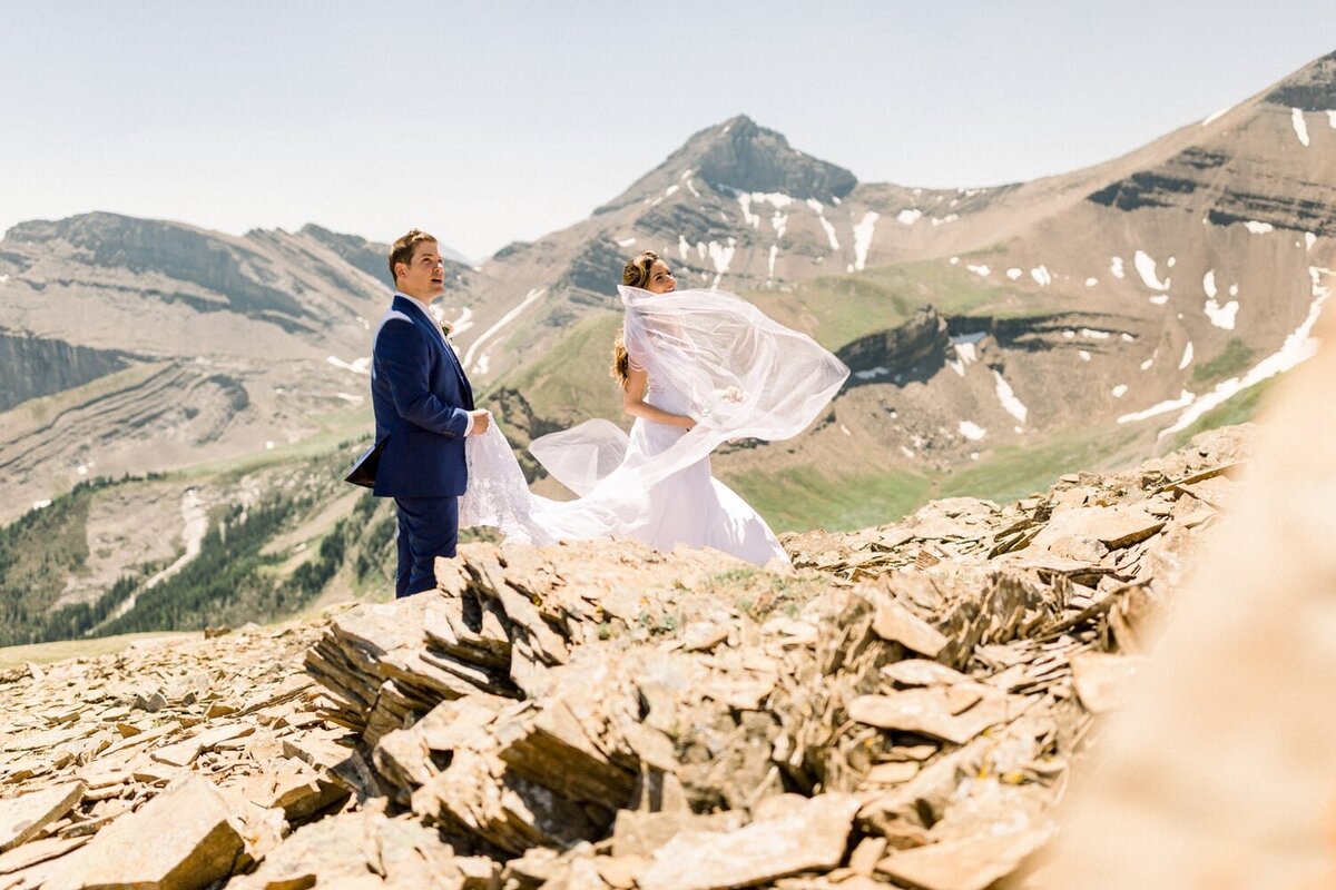 groom-and-bride-looking-up-to-their-ceremony-mountain-elopement-location