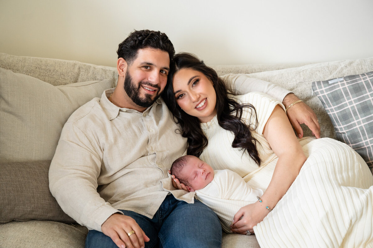 parents smiling with their baby in their shadyside pittsburgh home