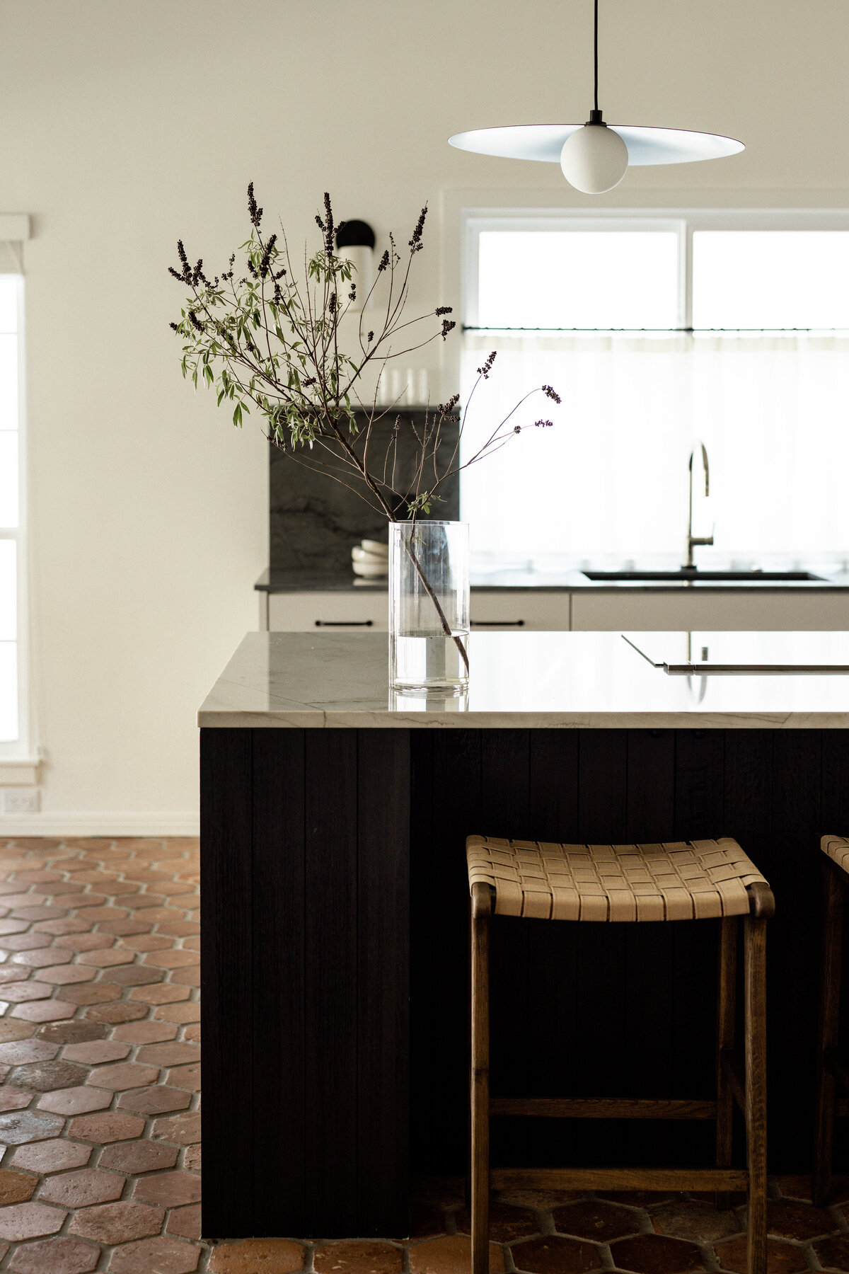 Timeless vintage cottage kitchen with antique terracotta tiles, stained oak island, and quartzite countertops by House Franc in Austin