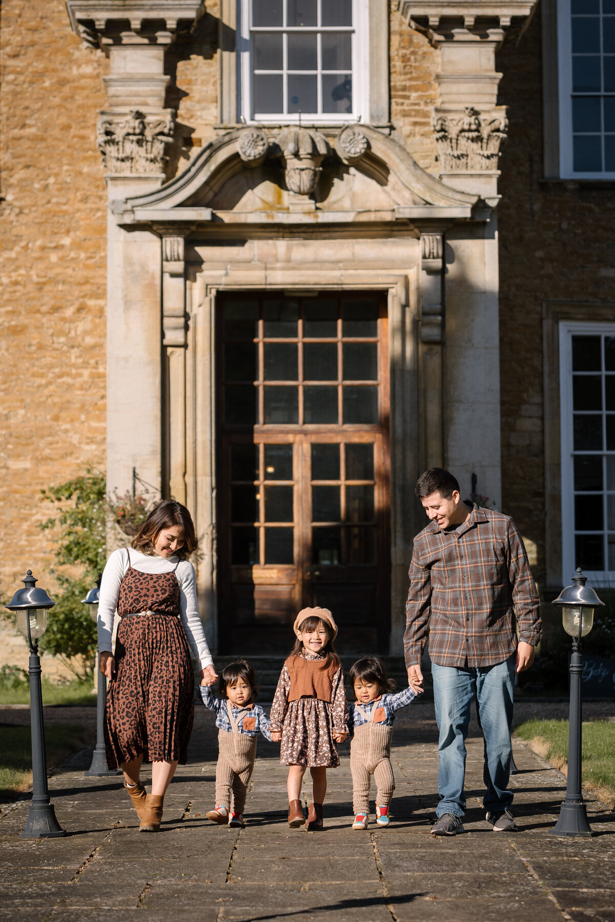 Family walking together holding hands at Hinwick Hall Bedfordshire