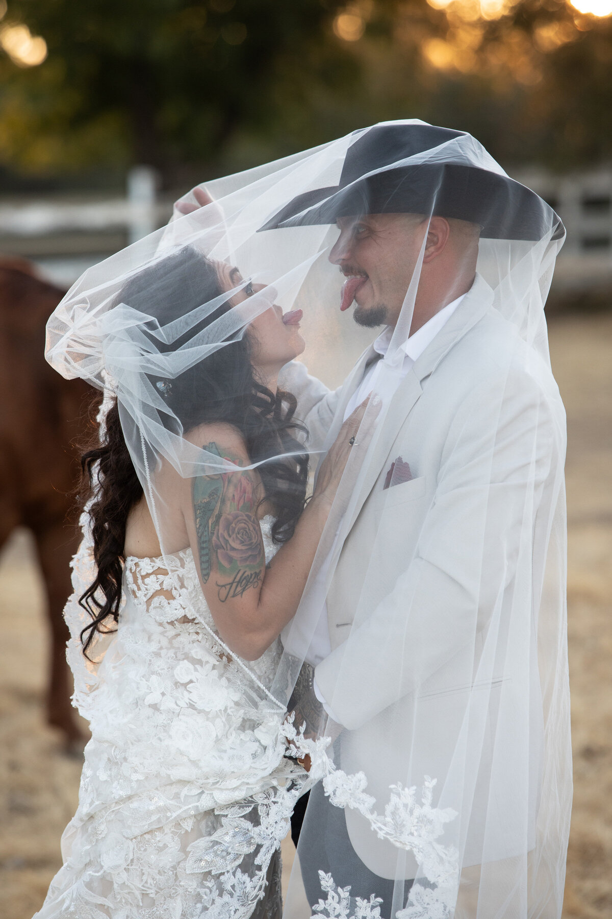 bride and groom sticking tongues out