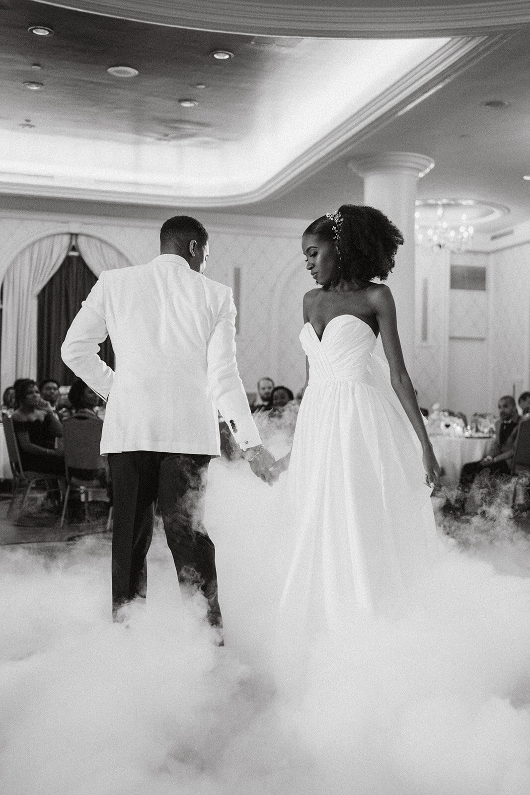 black newlyweds dance at wedding reception smoke on floor