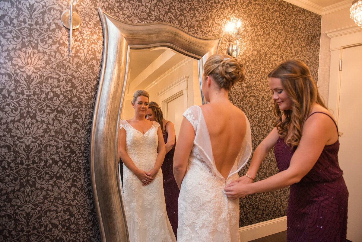 bride getting help with her dress at Heritage Club at Bethpage