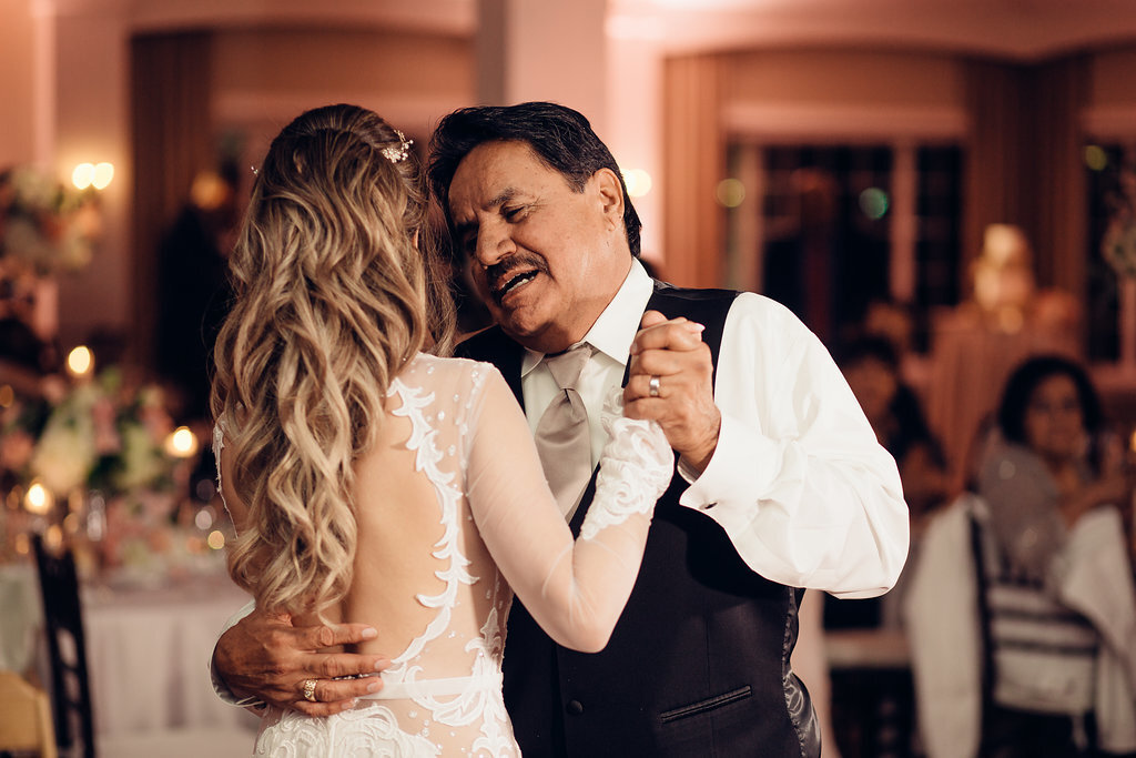 Wedding Photograph Of Man Whispering While Dancing With The Bride Los Angeles