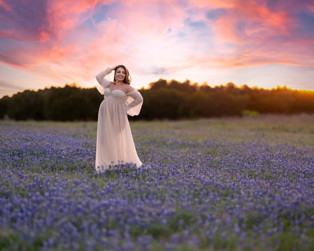 Maternity photography in Texas bluebonnet field during golden hour sunset session