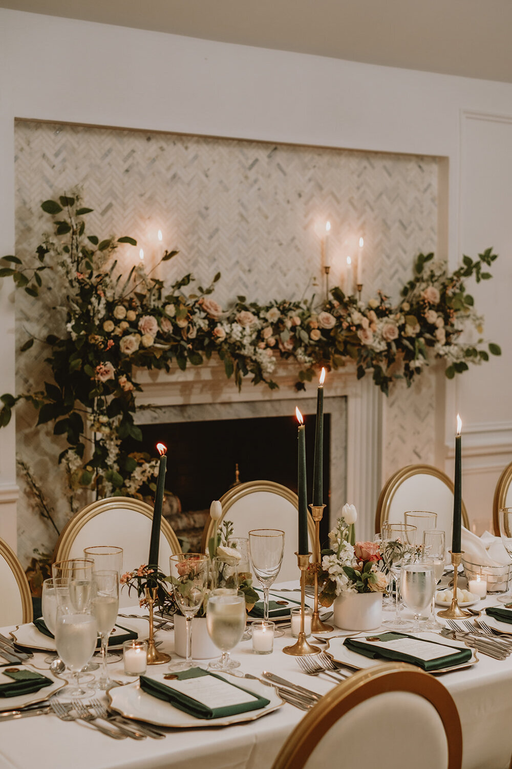 A fireplace at the Atwater Club draped in a meadow of garden flowers at a wedding reception. 