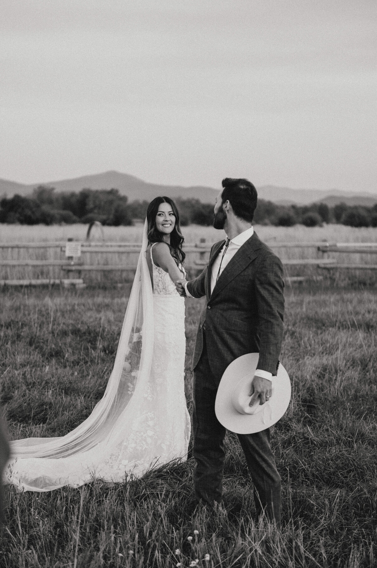 bride and groom posing on a ranch