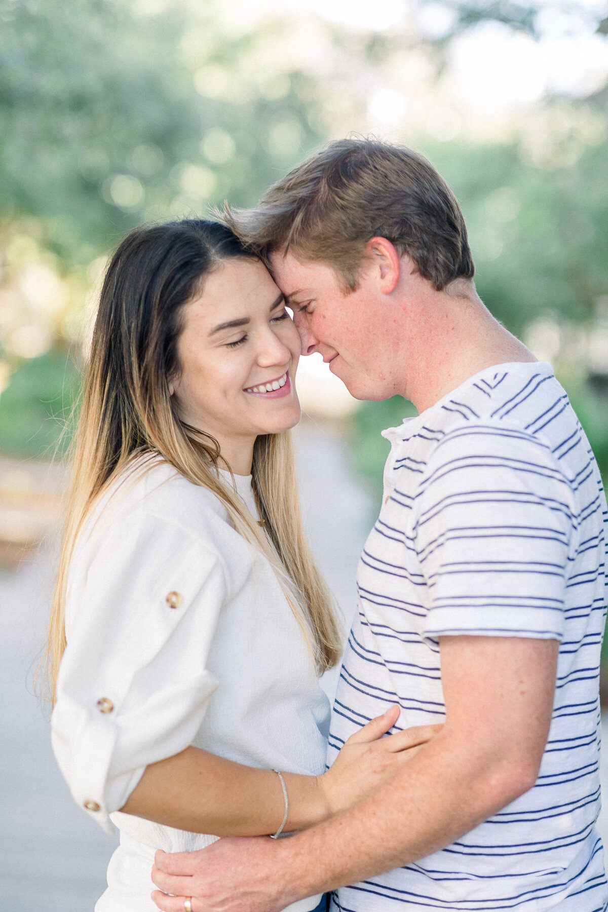 Couple holding each other and smiling captured by Staci Addison Photography