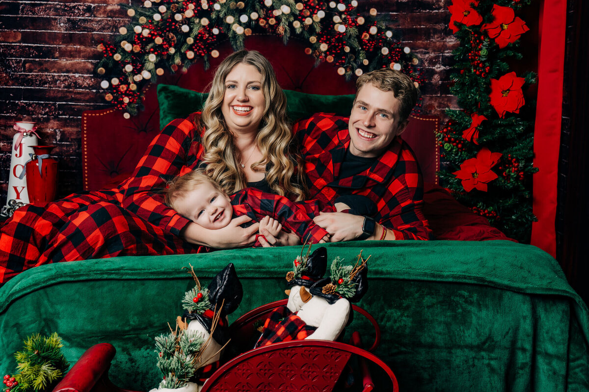 Parents hug baby boy in holiday Prescott family photos by Melissa Byrne