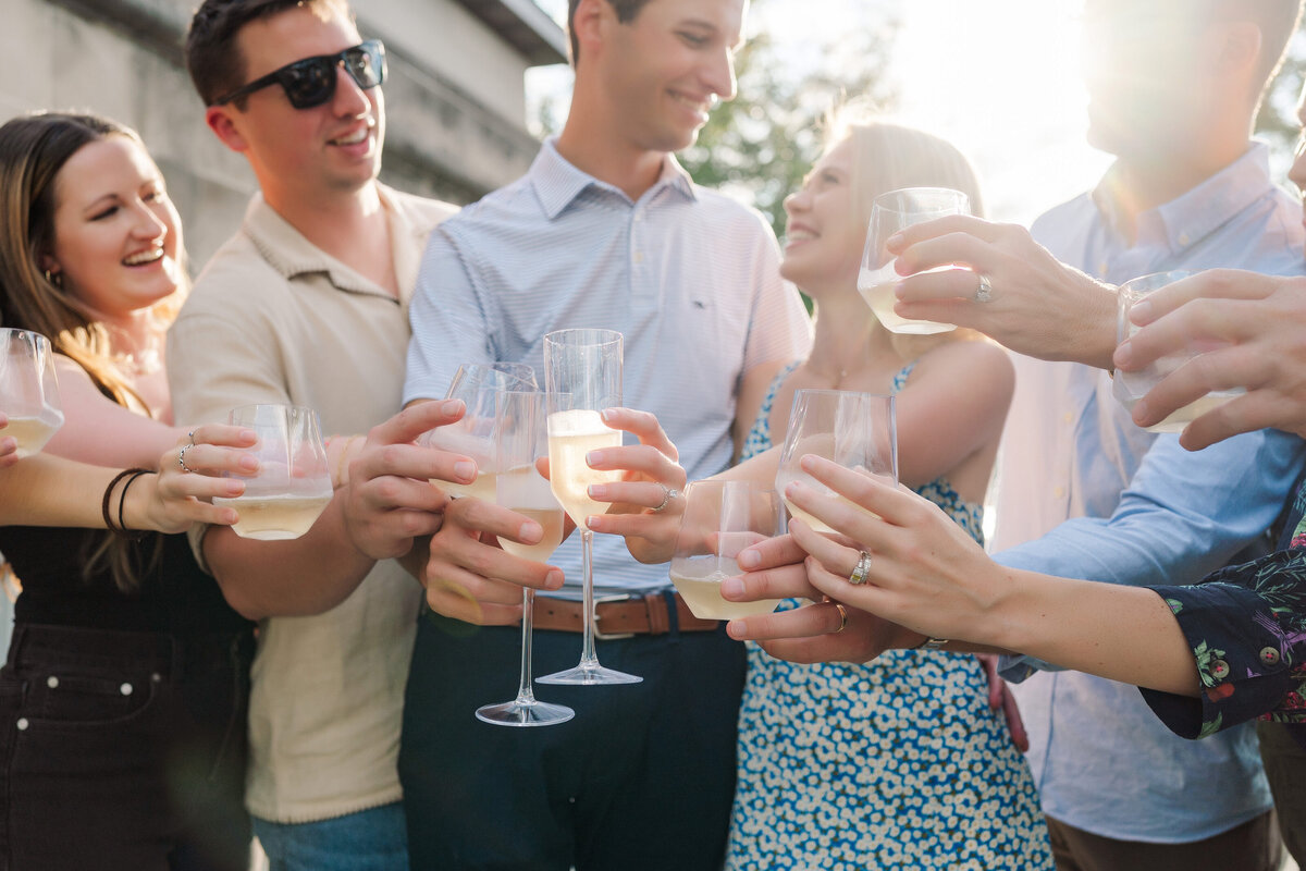 toast champagne proposal photo family celebrating