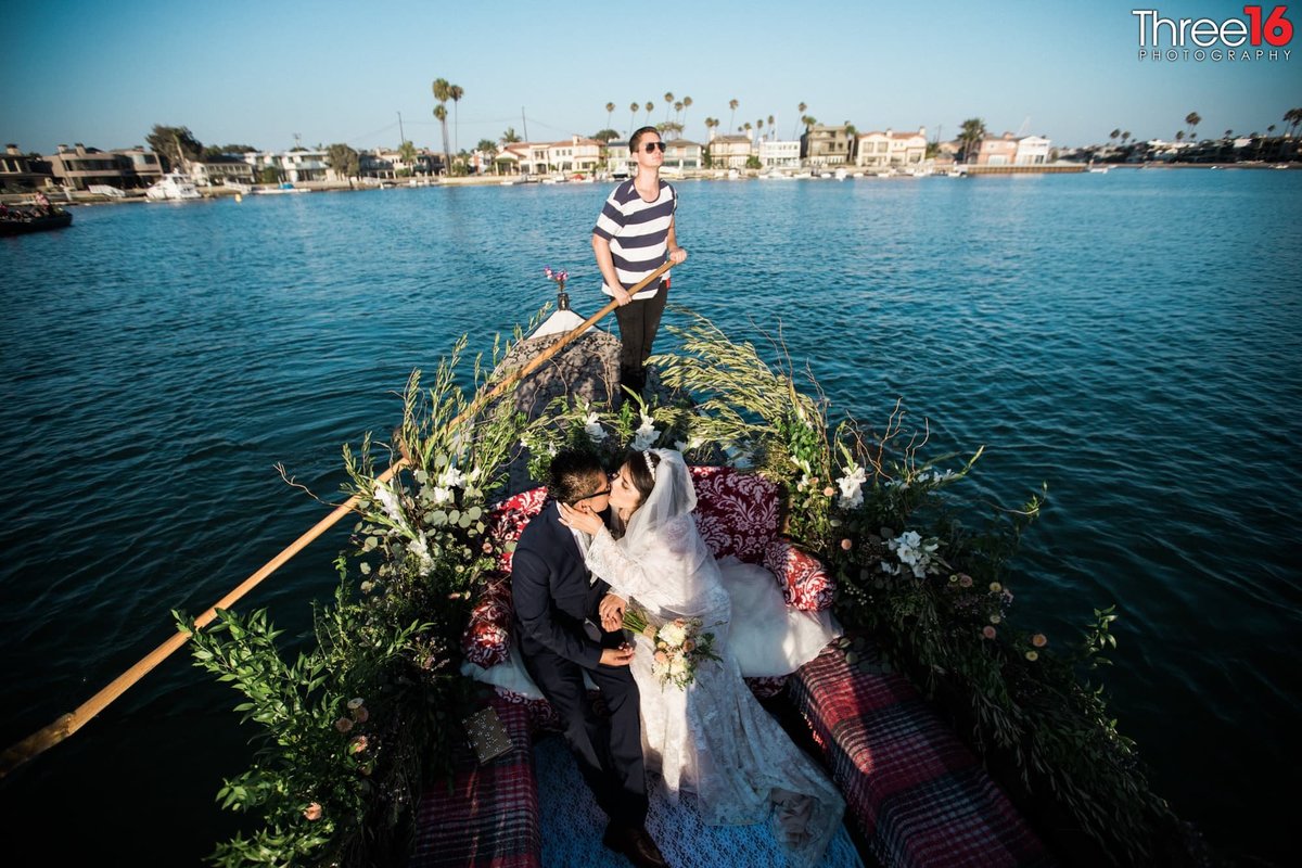Bride and Groom share their first kiss during a Gondola Getaway wedding ceremony in Long Beach Harbor