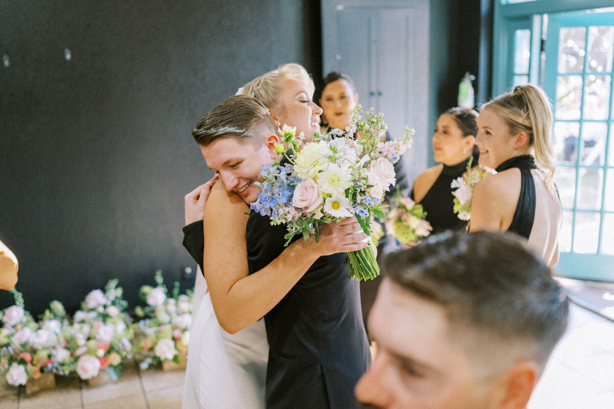 little-brother-hugging-bride-after-ceremony